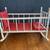 DOLL CRADLE, WHITE PAINTED WOOD, RED FLORAL BEDDING,25.5L x18.5Wx18.5H 1 thumbnail