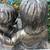 An enchanting siblings reading on bench garden statue 6 thumbnail