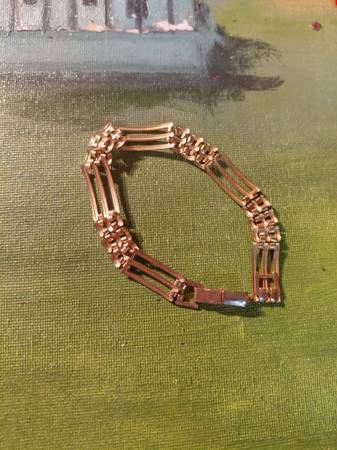 antique or vintage gold gate bracelet, often crafted in 9ct yellow gold with a r 1
