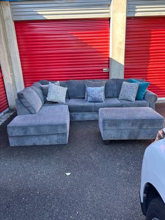 13 months old Like new gray L shape sectional with ottoman that has storage $650 1