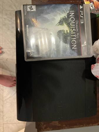 PS3 with cords and Dragon Age Inquisition 1
