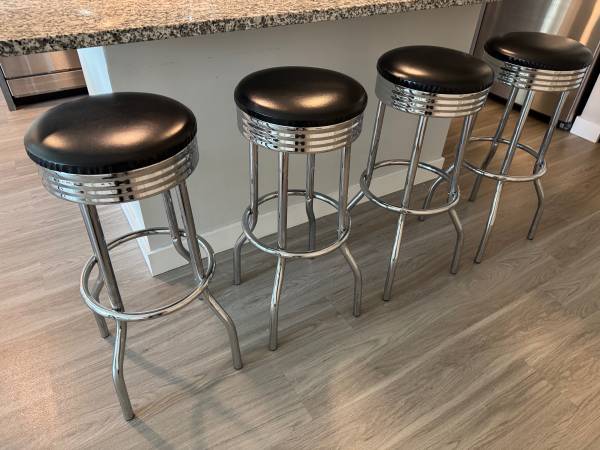 Four stainless steel and leather bar stools with swivel tops 1