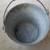 OLD METAL BUCKET WITH BULGING BOTTOM AND HANDLE 2 thumbnail