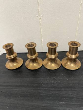 A set of four small vintage taper candlesticks 1