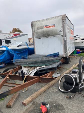 A RV trailer with box on top 1