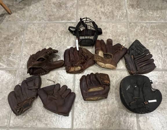 Old leather baseball gloves, catcher’s mitt and mask 1