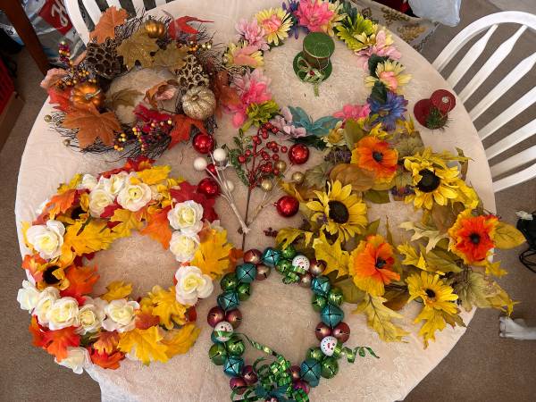 Several seasonal decorative wreaths and crafting materials. 1