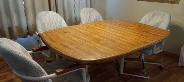 Casual Dining Table with Four Swivel Rolling Chairs 1